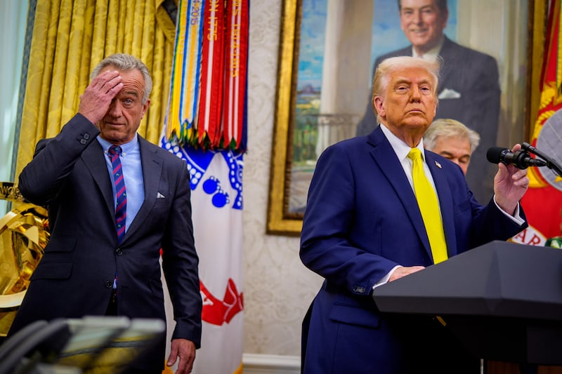 President Donald Trump, accompanied by Health and Human Services Secretary Robert F. Kennedy Jr. (L), takes a question from a reporter during a swearing in ceremony for Dr. Mehmet Oz as Medicare and Medicaid Services Administrator in the Oval Office at the White House on April 18, 2025 in Washington, DC. Oz spoke of a desire to provide America access to great care while reducing chronic disease and modernizing Medicare and Medicaid.
