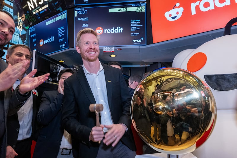 Reddit CEO Steve Huffman stands on the floor of the New York Stock Exchange after ringing a bell on the floor to set the app's share price in March 2024.