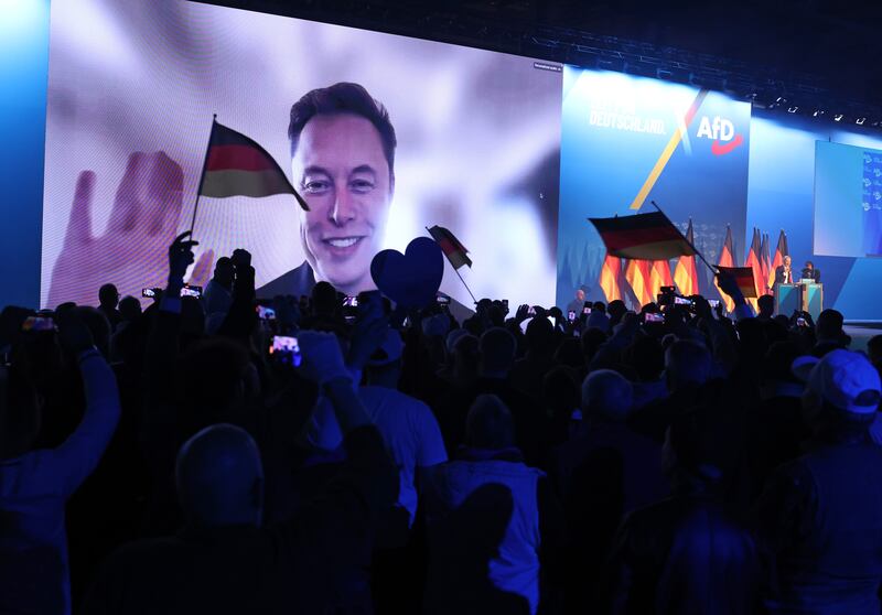 Tech billionaire Elon Musk waves and speaks live via a video transmission during a speech by Alice Weidel during a rally with the far-right Alternative for Germany (AfD) political party.