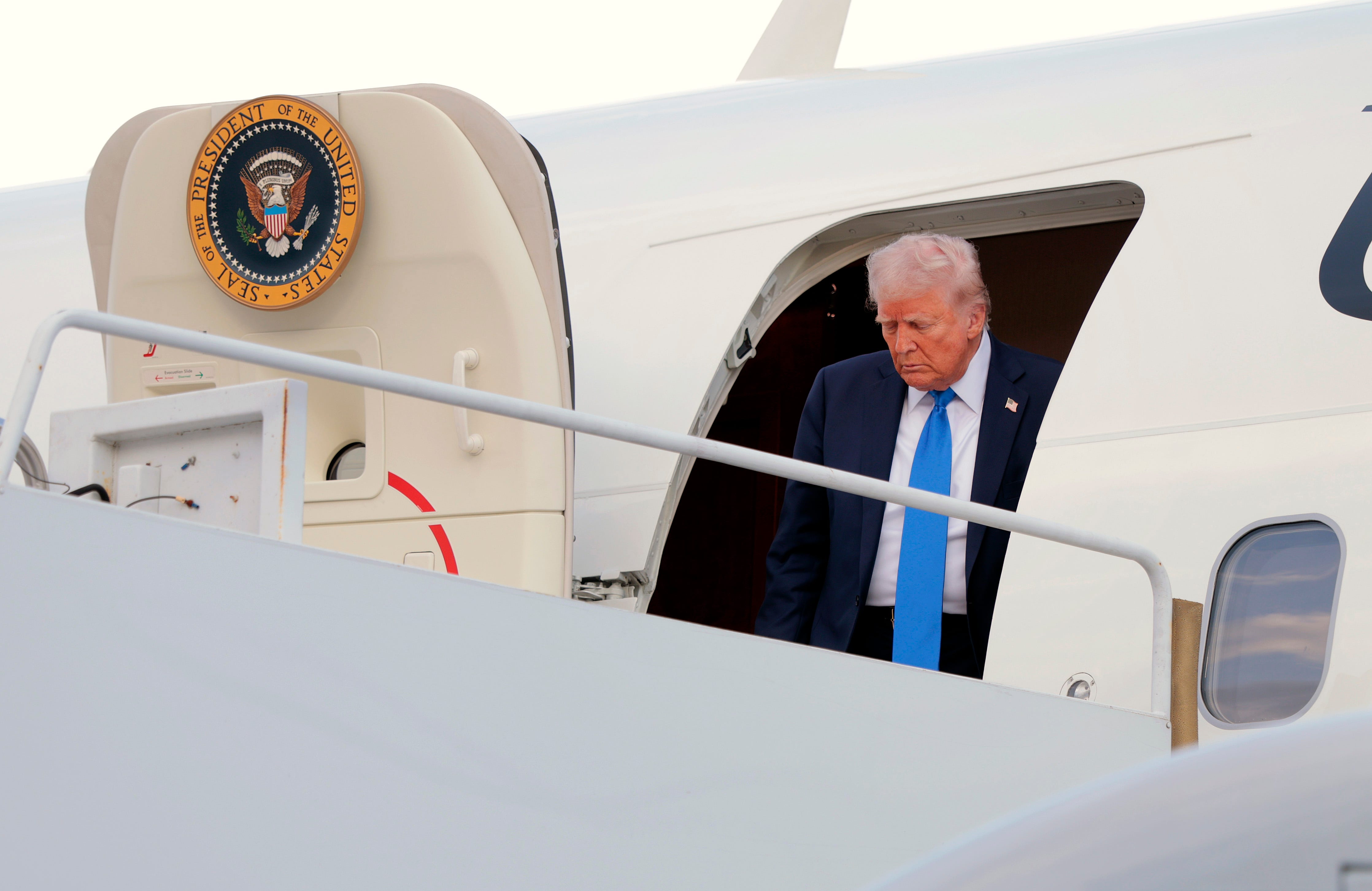 President Donald Trump disembarks from Air Force One at Tuscaloosa National Airport.