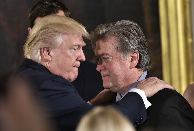 US President Donald Trump (L) congratulates Stephen Bannon.