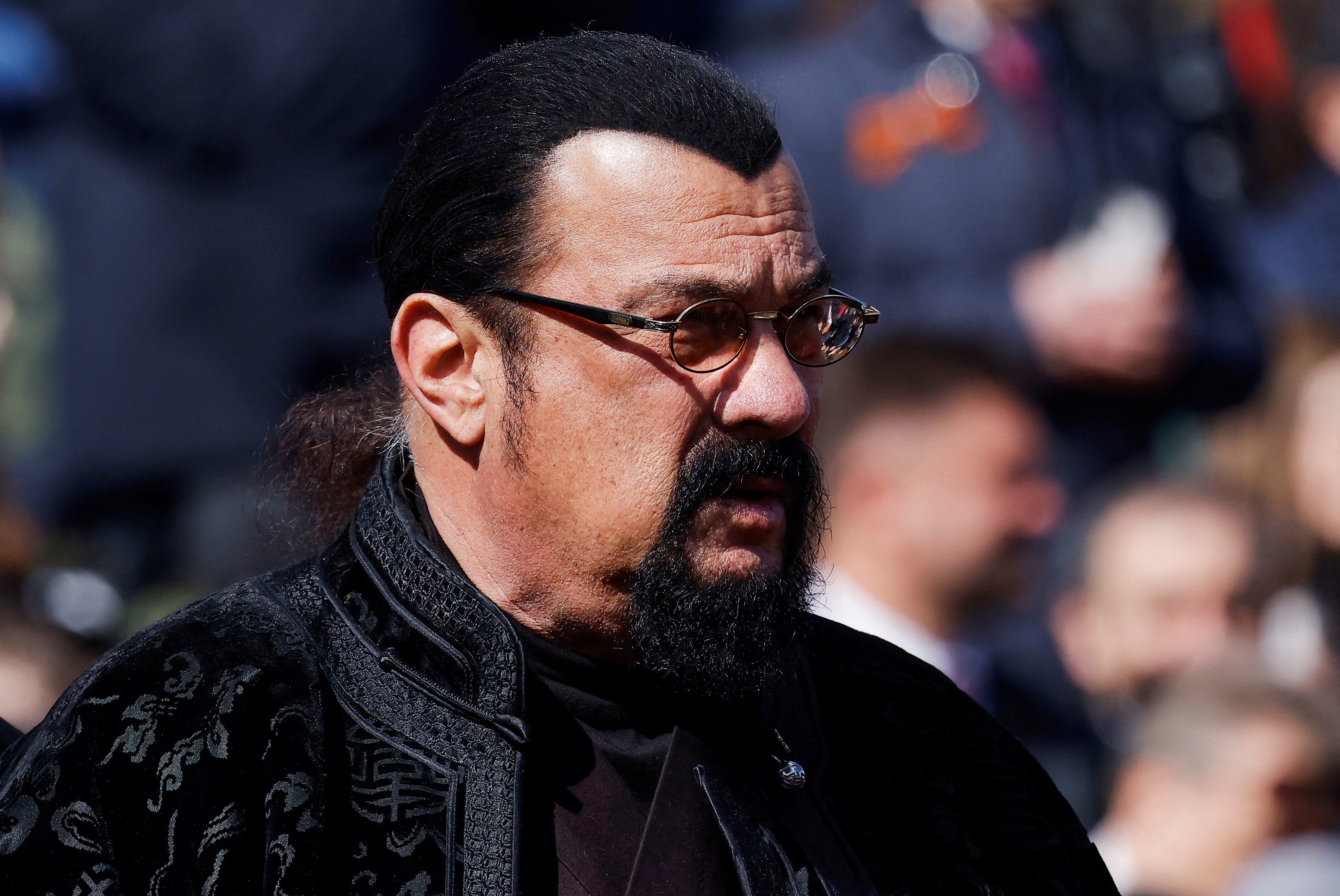 Steven Seagal, donning glasses, is seen amid a crowd at Russia's Victory Day parade.