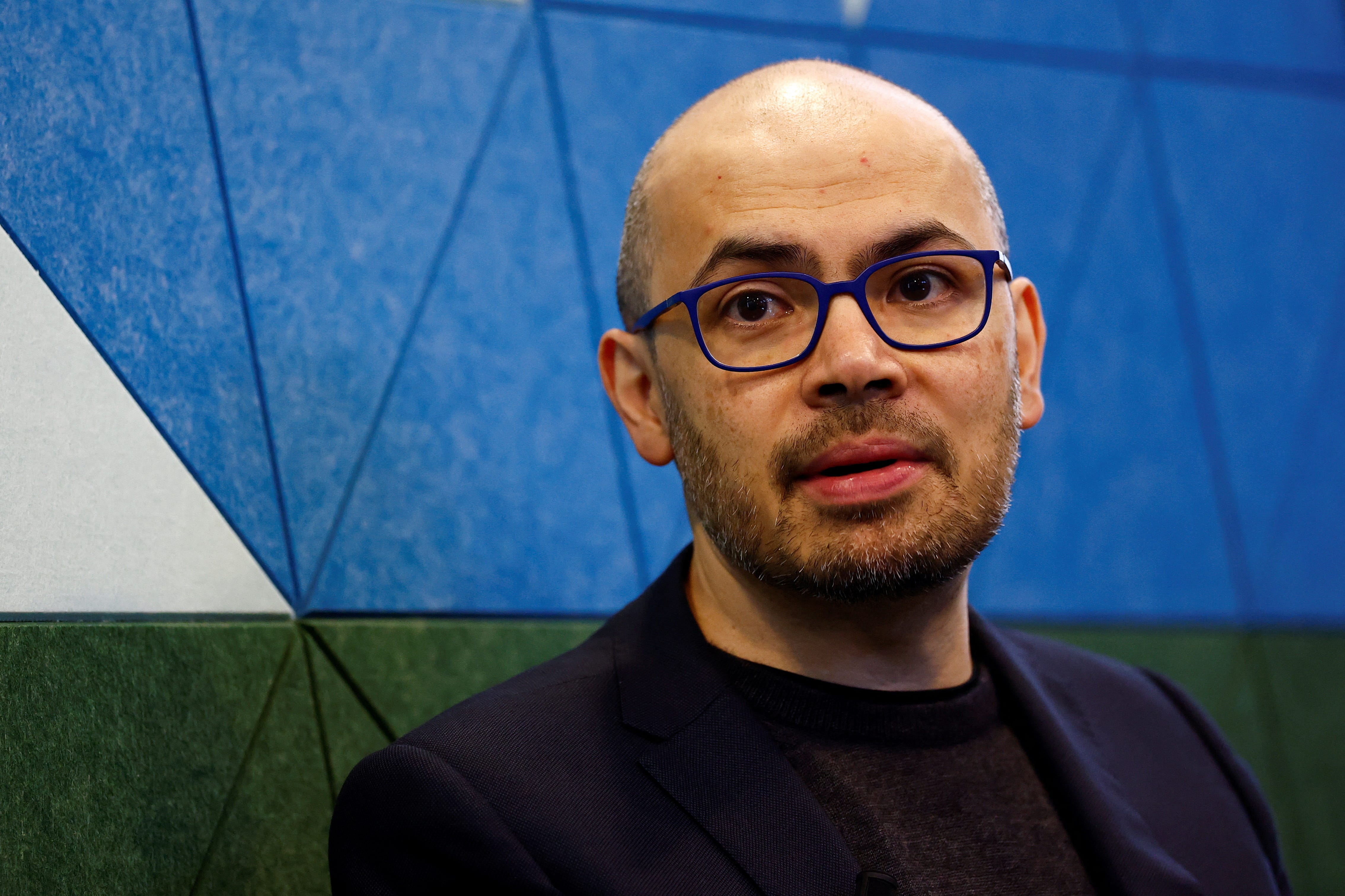 Demis Hassabis speaks at a Google press event before the AI Action Summit.