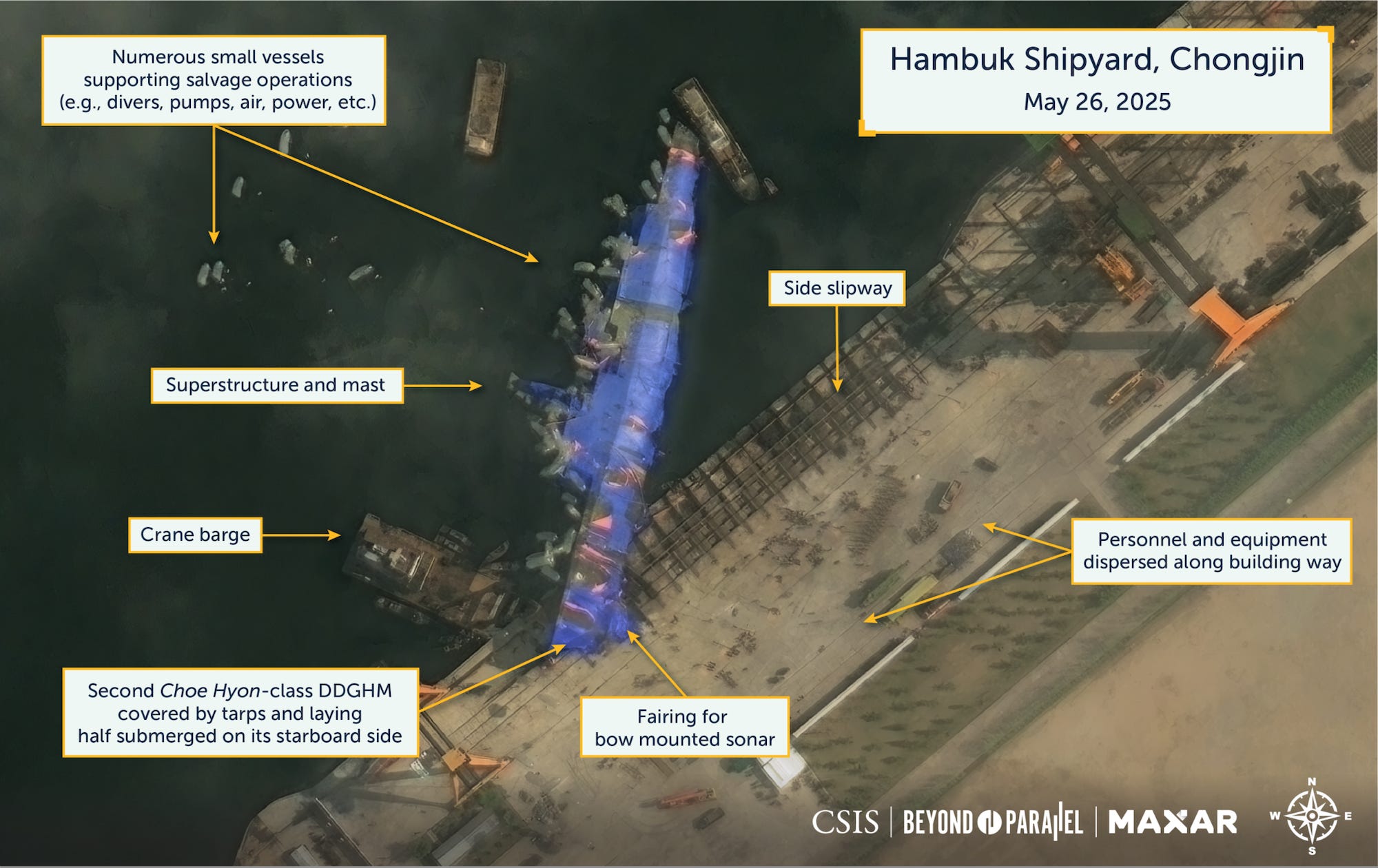 A May 26 satellite image of North Korea's stricken destroyer shows a crane barge nearby and numerous small vessels likely dewatering the ship's flooded aft section.