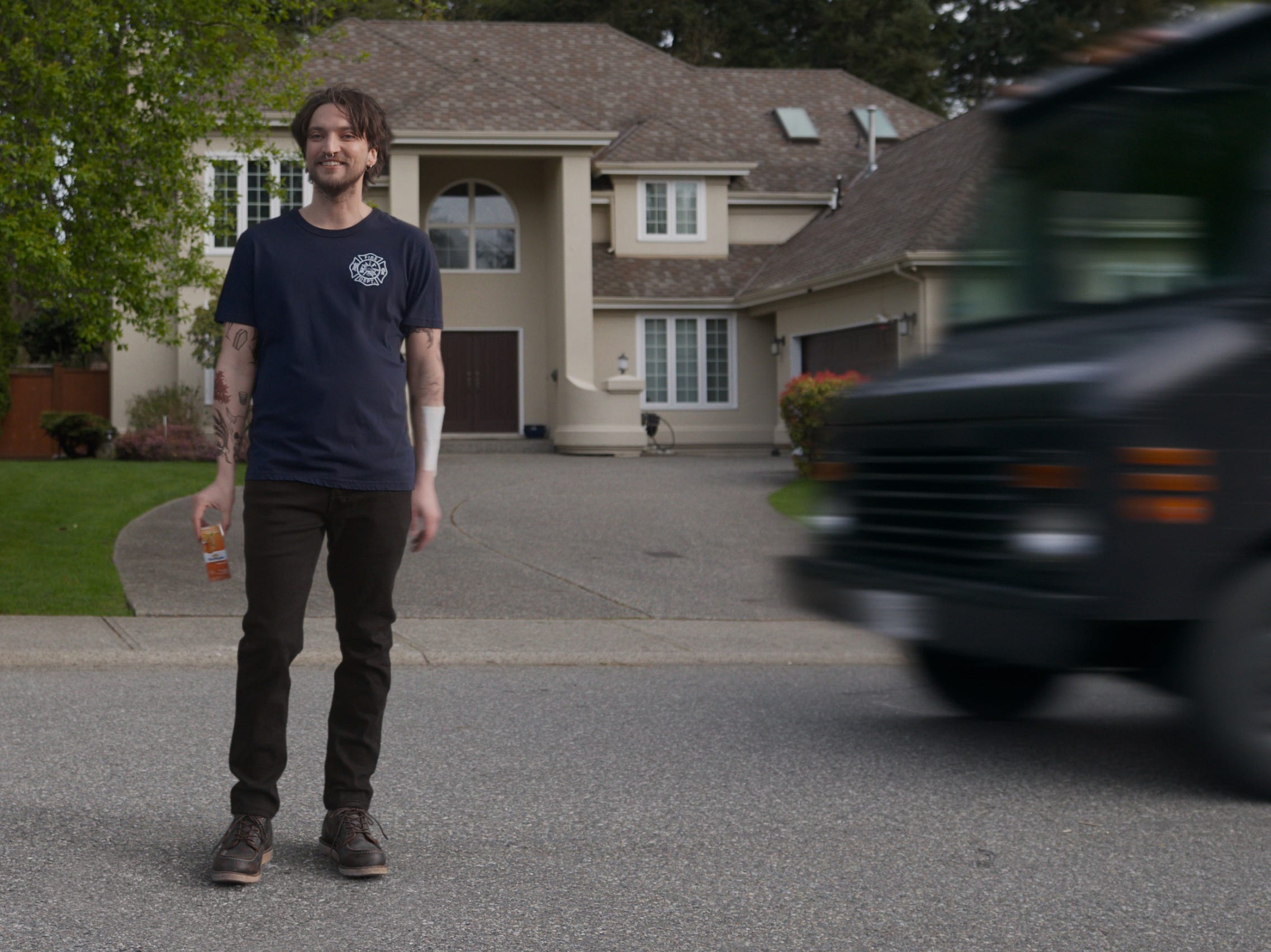 A scene in "Final Destination: Bloodlines" where a character stands in the middle of a residential road.