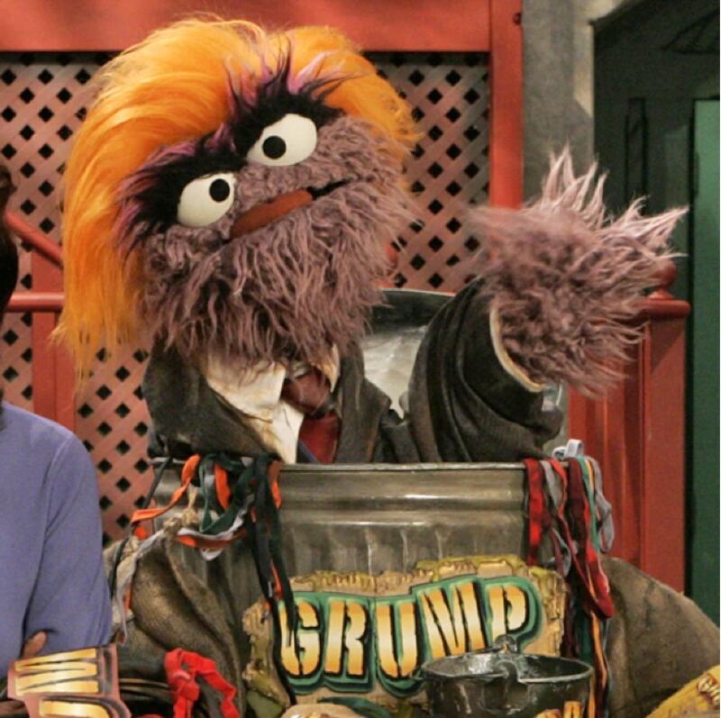 Oscar the Grouch with orange wig, "Grump" painted on his garbage can.