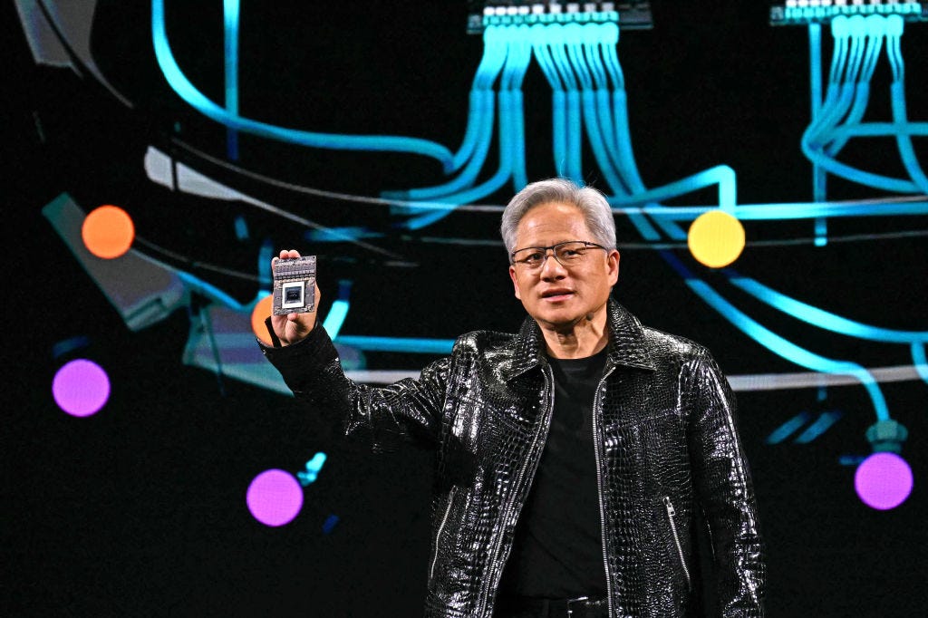 Jensen Huang holding up a chip at the CES in Las Vegas
