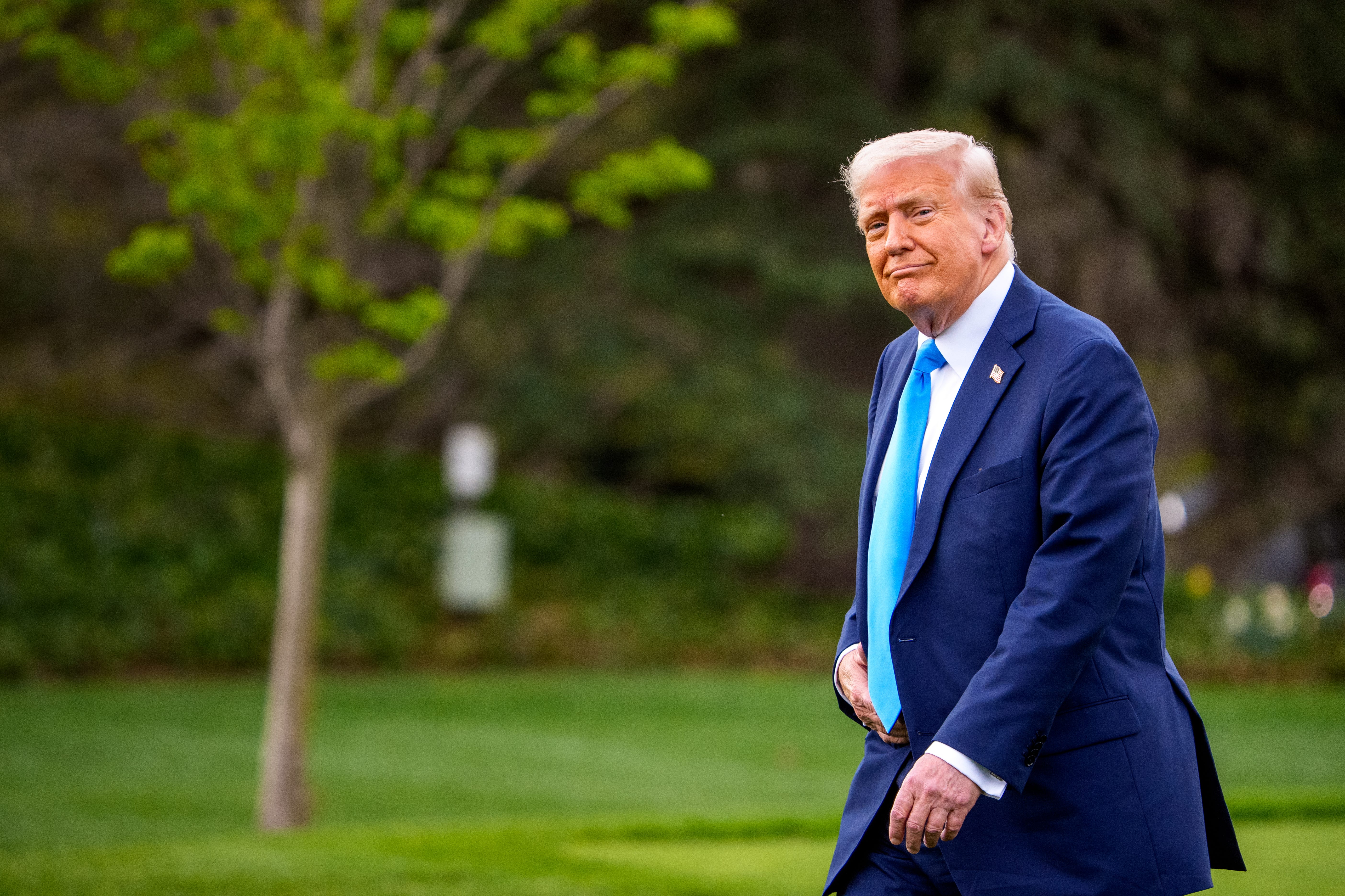 Donald Trump in a blue suit with a blue tie.