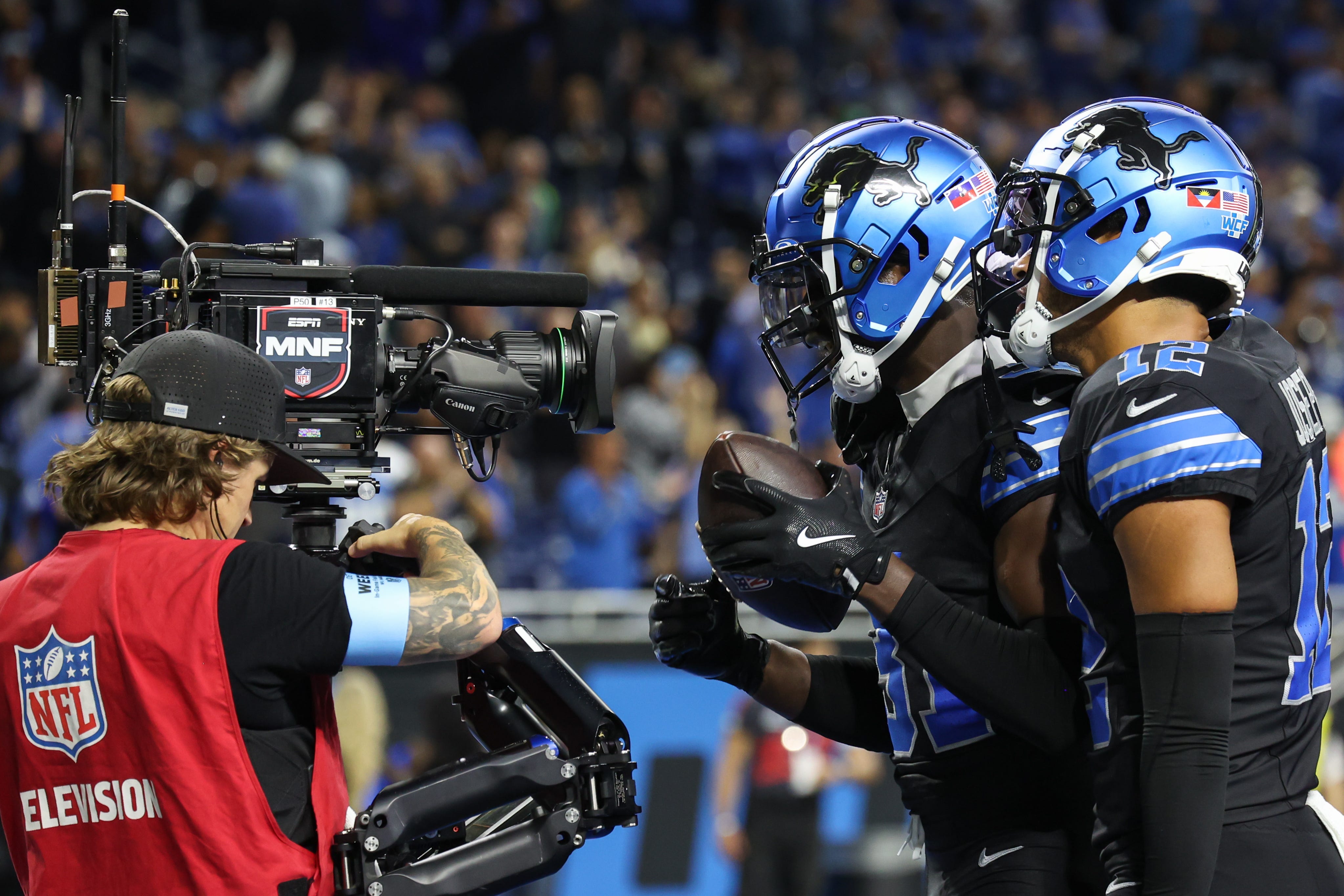 Detroit Lions safety Kerby Joseph (31) celebrates in front of the ESPN Monday Night Football television camera
