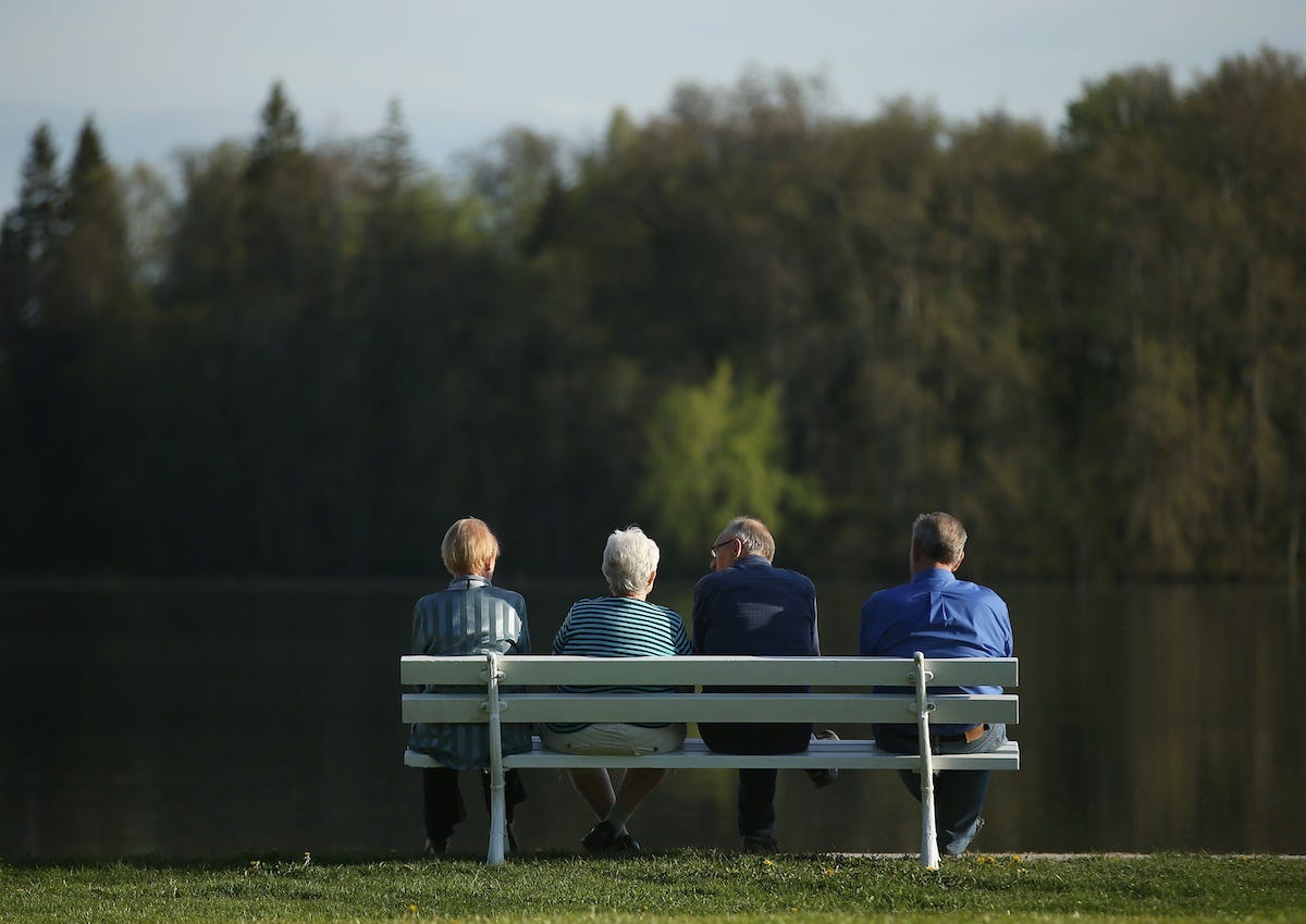 retirees sitting lake
