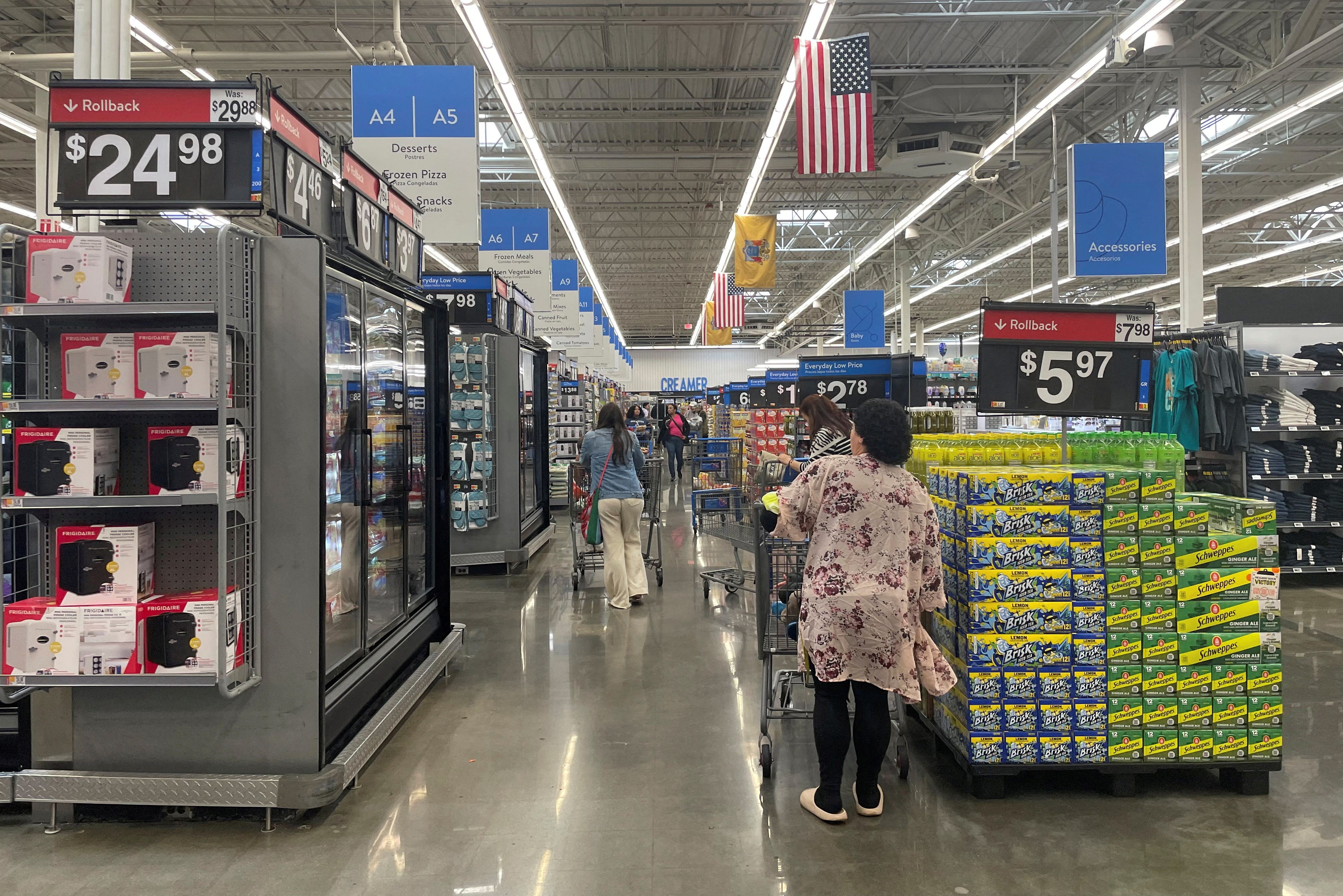 FILE PHOTO: Shoppers browse a Walmart Supercenter a day after U.S. President Donald Trump announced new tariffs, in Secaucus