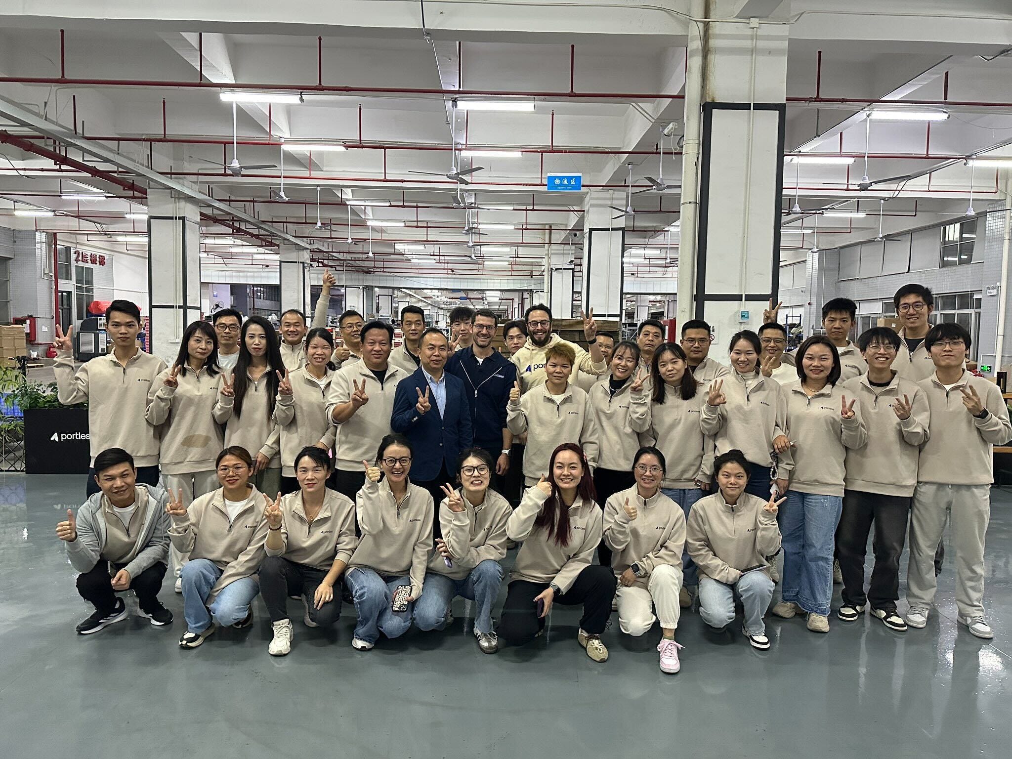 Employees smile inside Portless' facility in Shenzhen, China