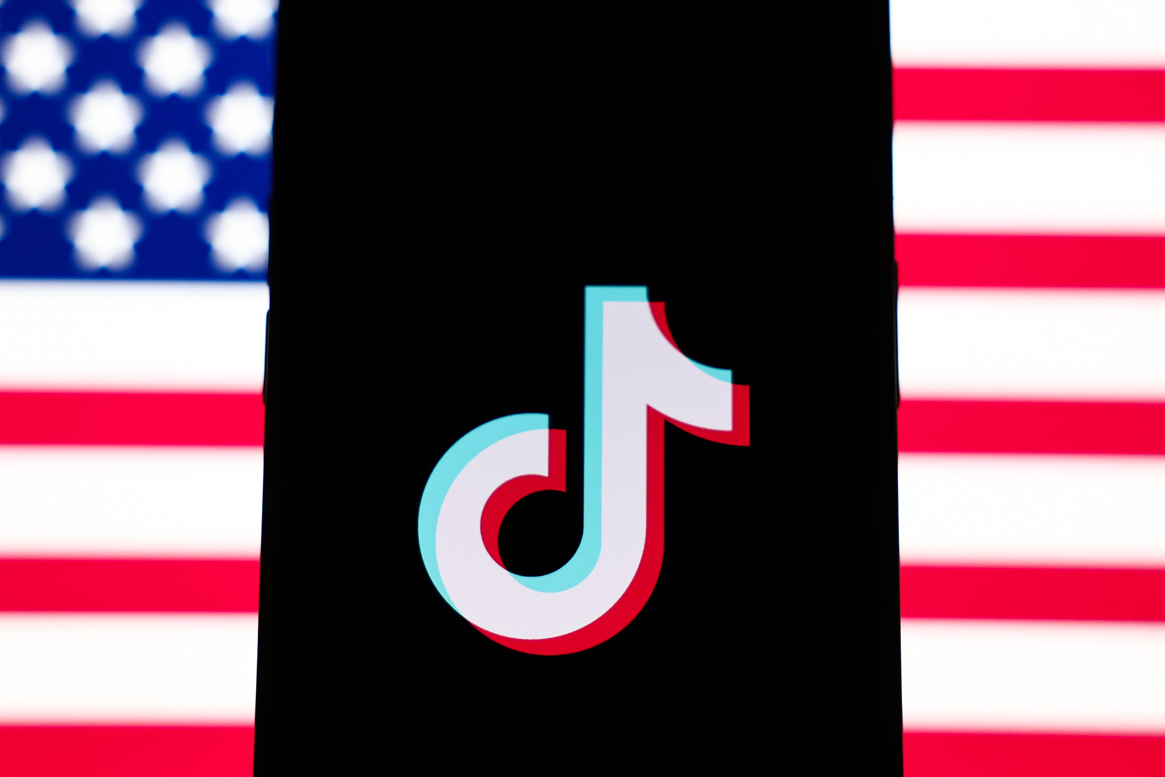 Tiktok logo in front of American flag