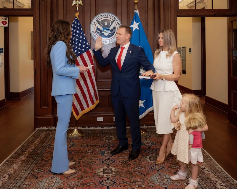 Andrew Giuliani is sworn in on Tuesday by DHS Secretary Kristi Noem. At his side is his wife, Živilė Rezgyte, and their daughter.