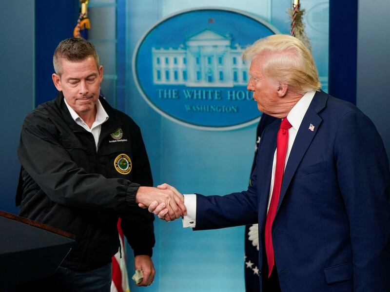 U.S. President Donald Trump greets Transportation Secretary Sean Duffy as they speak to reporters about Wednesday's deadly midair collision between a U.S. Army Black Hawk helicopter and American Eagle flight 5342 near Ronald Reagan Washington National Airport, in the Brady Press Briefing Room at the White House in Washington, U.S., January 30, 2025. REUTERS/Elizabeth Frantz