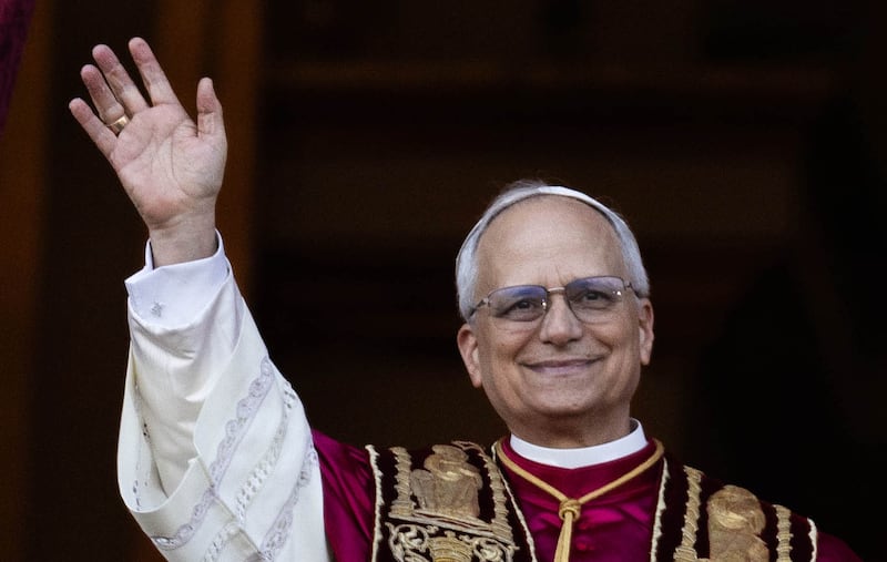 Pope Leo XIV emerges onto the balcony of St. Peter’s Basilica.