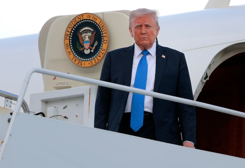 Donald Trump looks down at the camera.