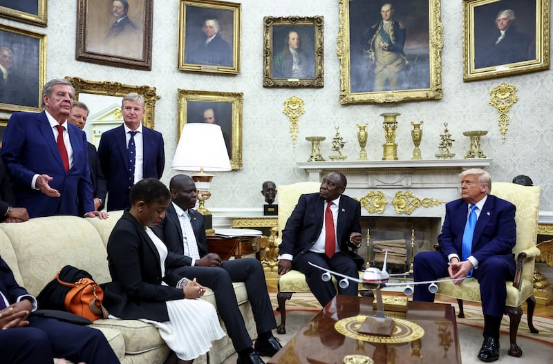 Businessman Johann Rupert speaks next to Golfers Retief Goosen and Ernie Els in the Oval Office, during a meeting between U.S. President Donald Trump and South African President Cyril Ramaphosa, at the White House in Washington, D.C.