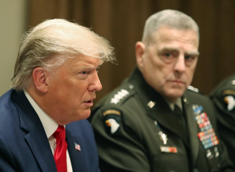 Former U.S. President Donald Trump speaks as former Joint Chiefs of Staff Chairman, Army Gen. Mark Milley looks on after getting a briefing from senior military leaders in the Cabinet Room at the White House on October 7, 2019 in Washington, DC.