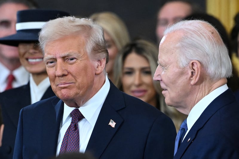 Joe Biden (right) looks on Donald Trump arrives for his 2025 inauguration ceremony.