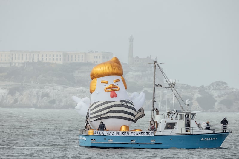 An inflatable caricature known as the Trump Chicken is seen aboard a ship traveling past Alcatraz Island and the Marina Green, as supporters of former U.S. President Donald Trump rally nearby ahead of a campaign fundraiser, in San Francisco, Thursday, June 6, 2024. (Photo by Stephen Lam/San Francisco Chronicle via Getty Images)