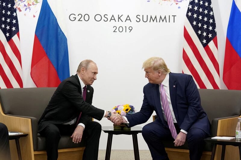 Russia's President Vladimir Putin and U.S. President Donald Trump shake hands during a bilateral meeting at the G20 leaders summit in Osaka, Japan,
