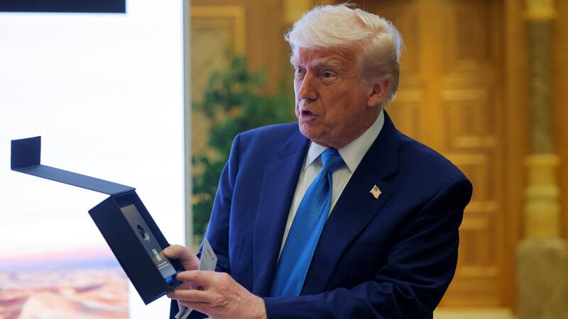Donald Trump holds a sample of oil that he was gifted in Abu Dhabi, United Arab Emirates.