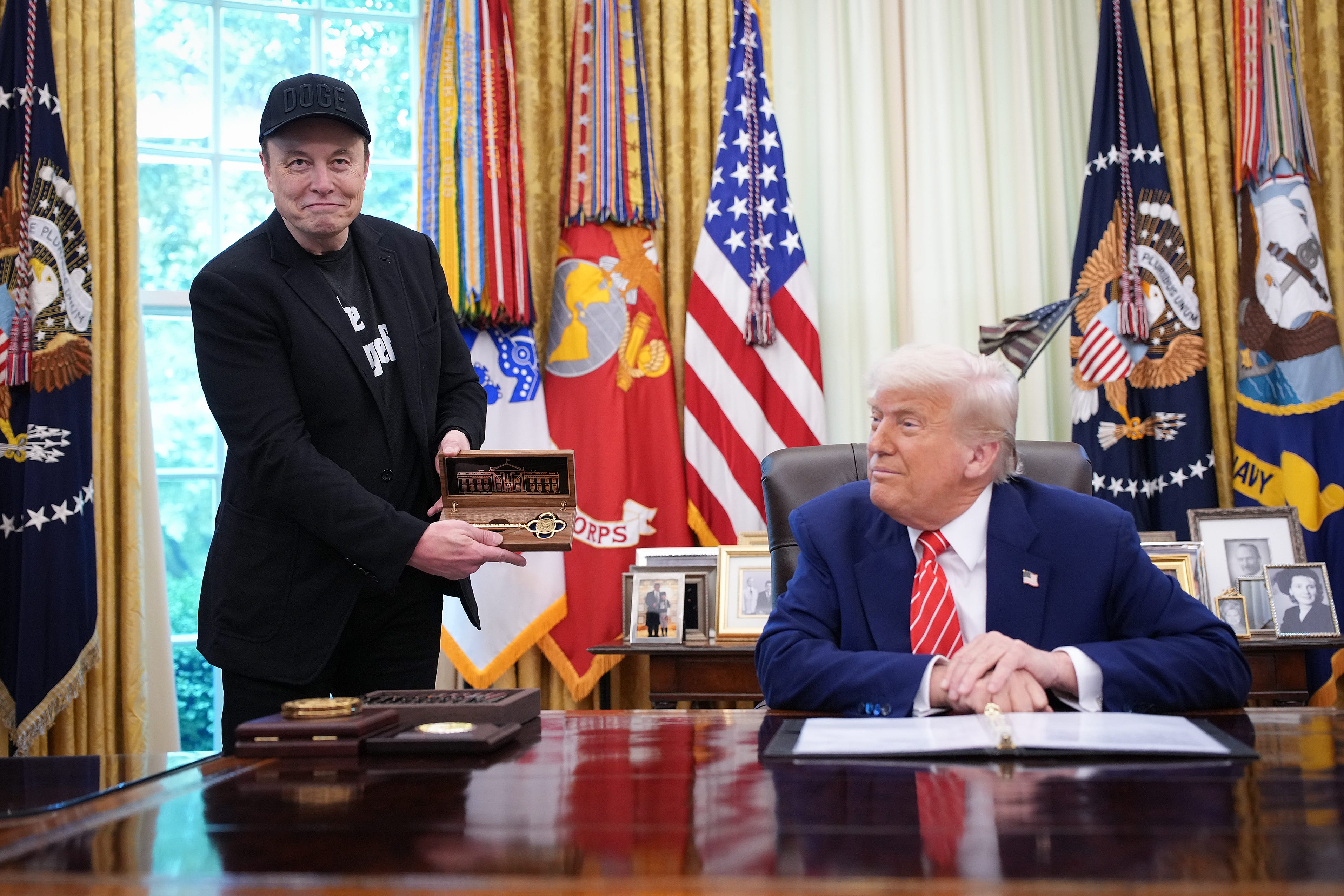 President Donald Trump gifts Elon Musk a key during a White House event on May 30, 2025.