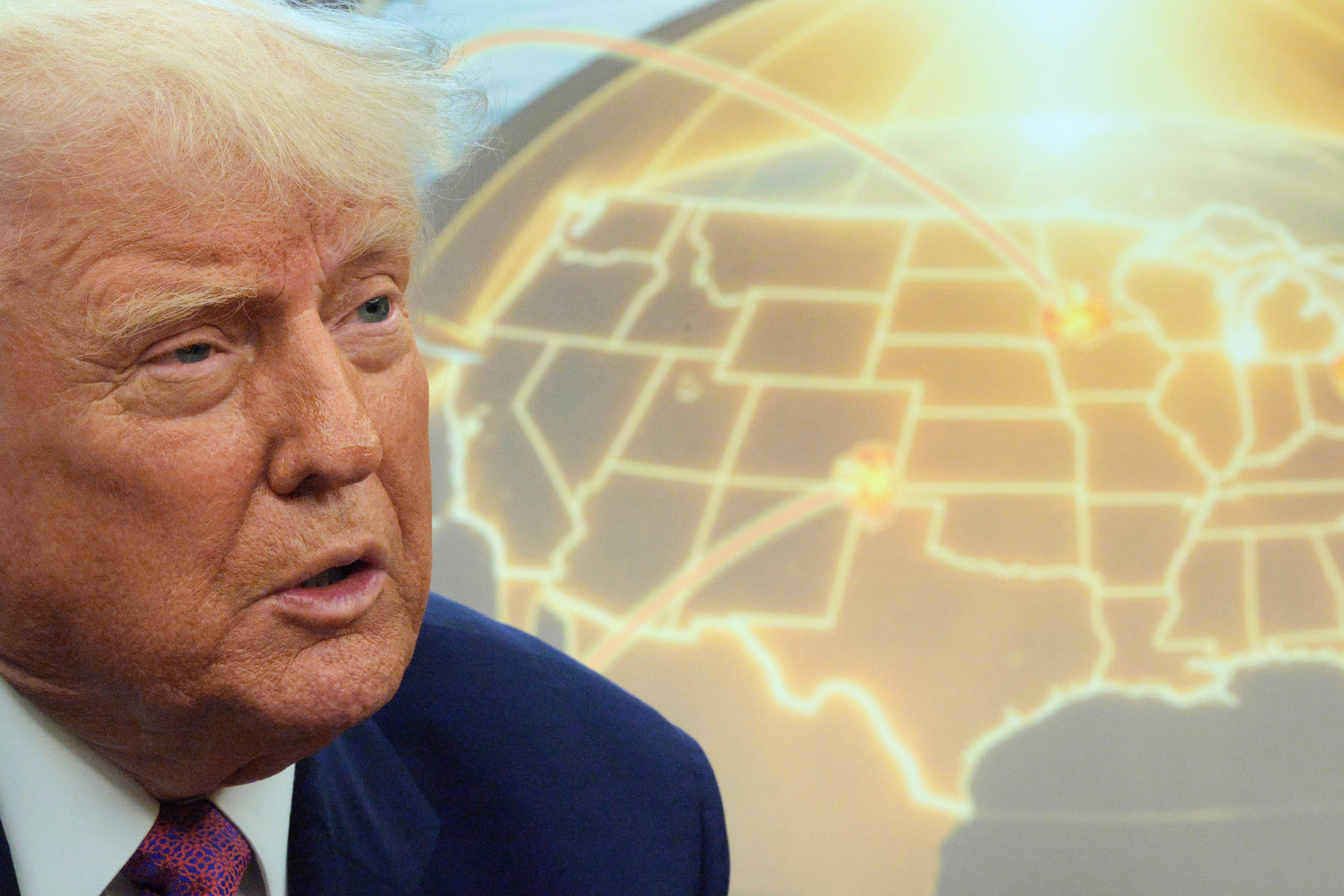 President Donald Trump speaks in front of a map of the proposed "Golden Dome" missile defense system in the Oval Office.