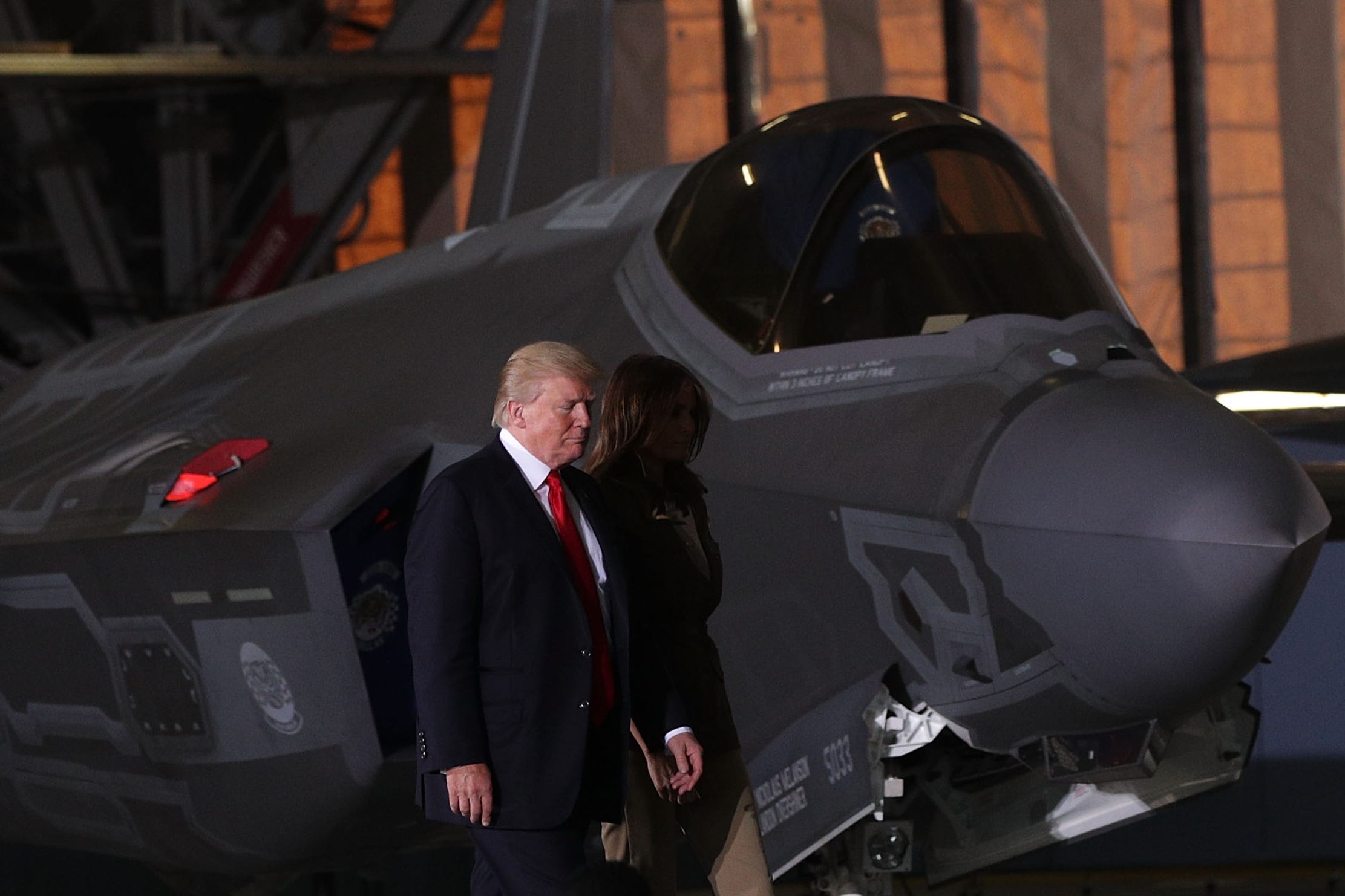 JOINT BASE ANDREWS, MD - SEPTEMBER 15: U.S. President Donald Trump and first lady Melania Trump walk in front of a F-35 fighter jet as they arrive at an event September 15, 2017 at Joint Base Andrews in Maryland. President Trump attended the event to celebrate the 70th birthday of the U.S. Air Force.