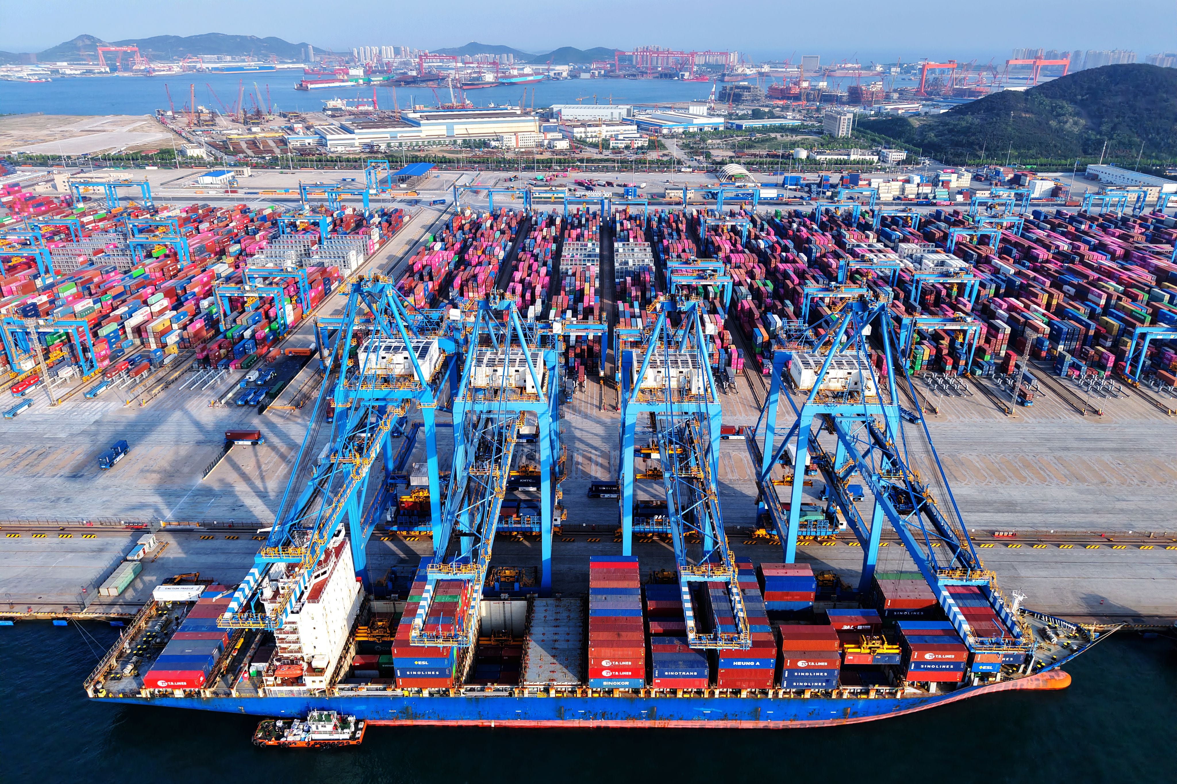Quay cranes serve a ship at a container terminal in Qingdao in east China's Shandong province Monday, May 12.