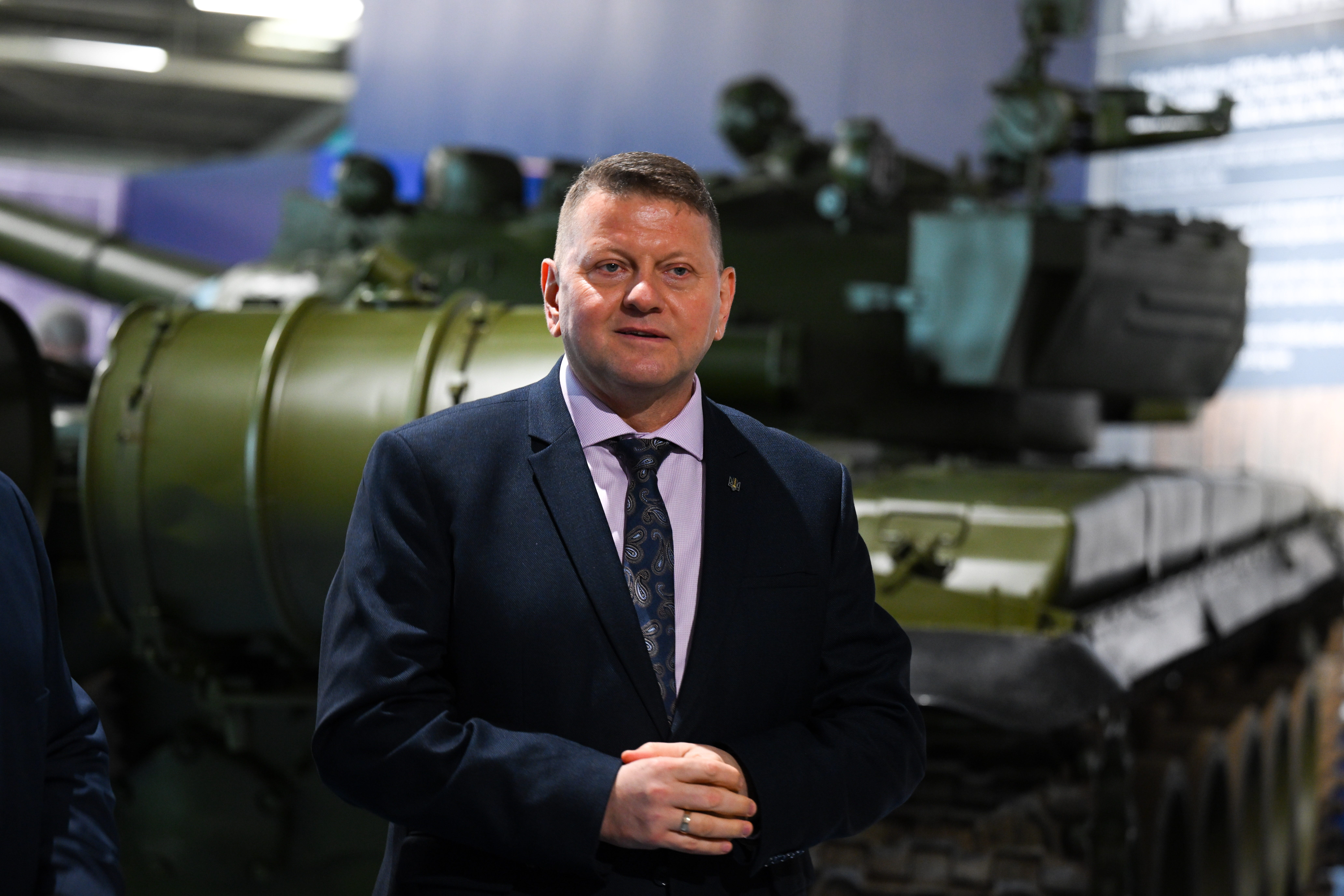 General Valerii Zaluzhnyi stands in front of military equipment in his role as ambassador to the UK.