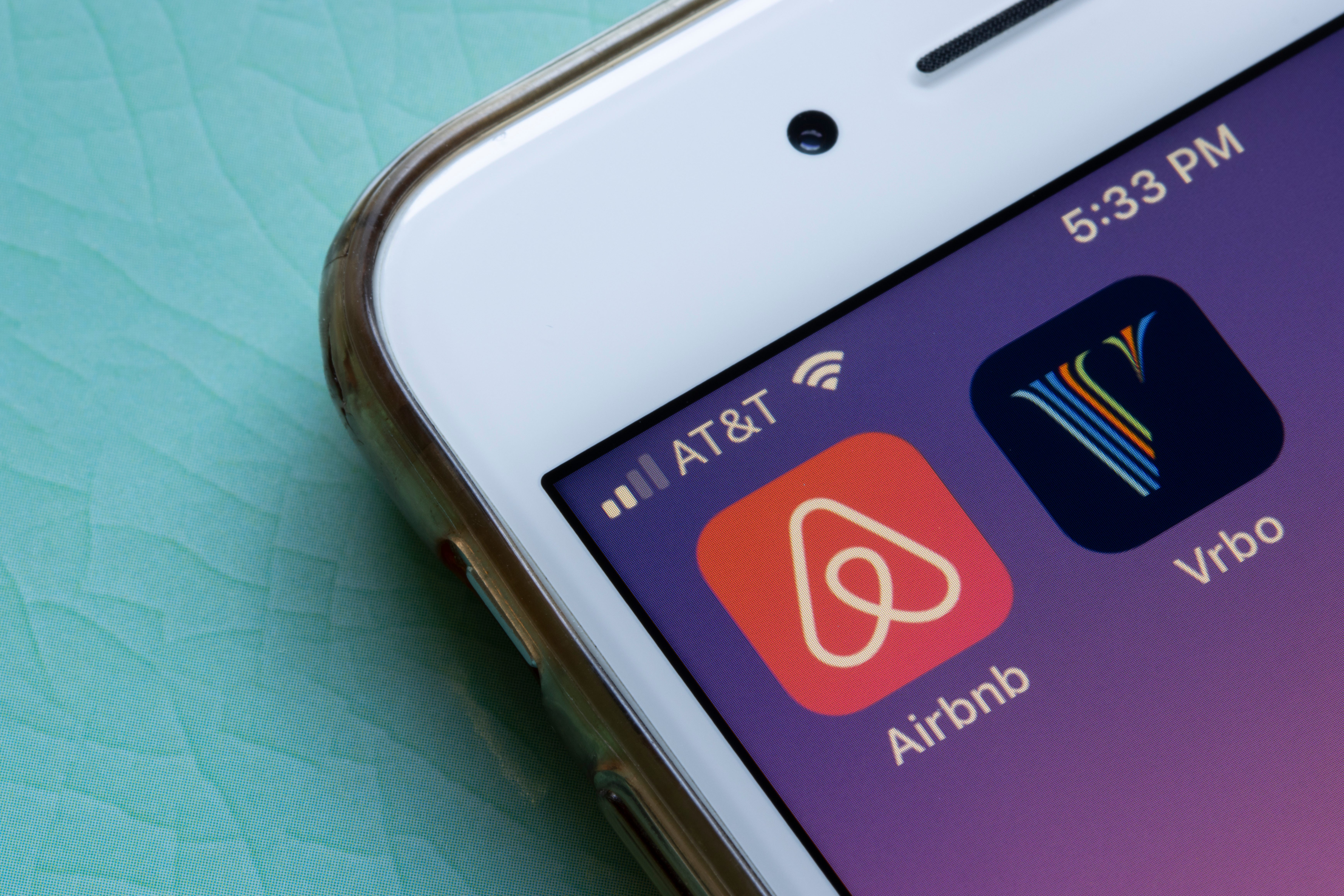 The Airbnb and Vrbo apps next to each other on an iPhone