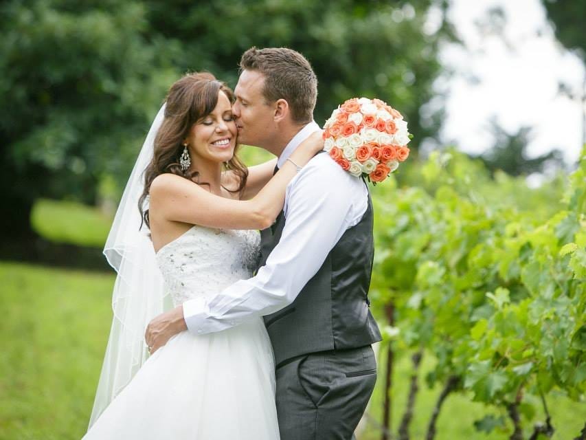 The author and her husband on their wedding day outside.