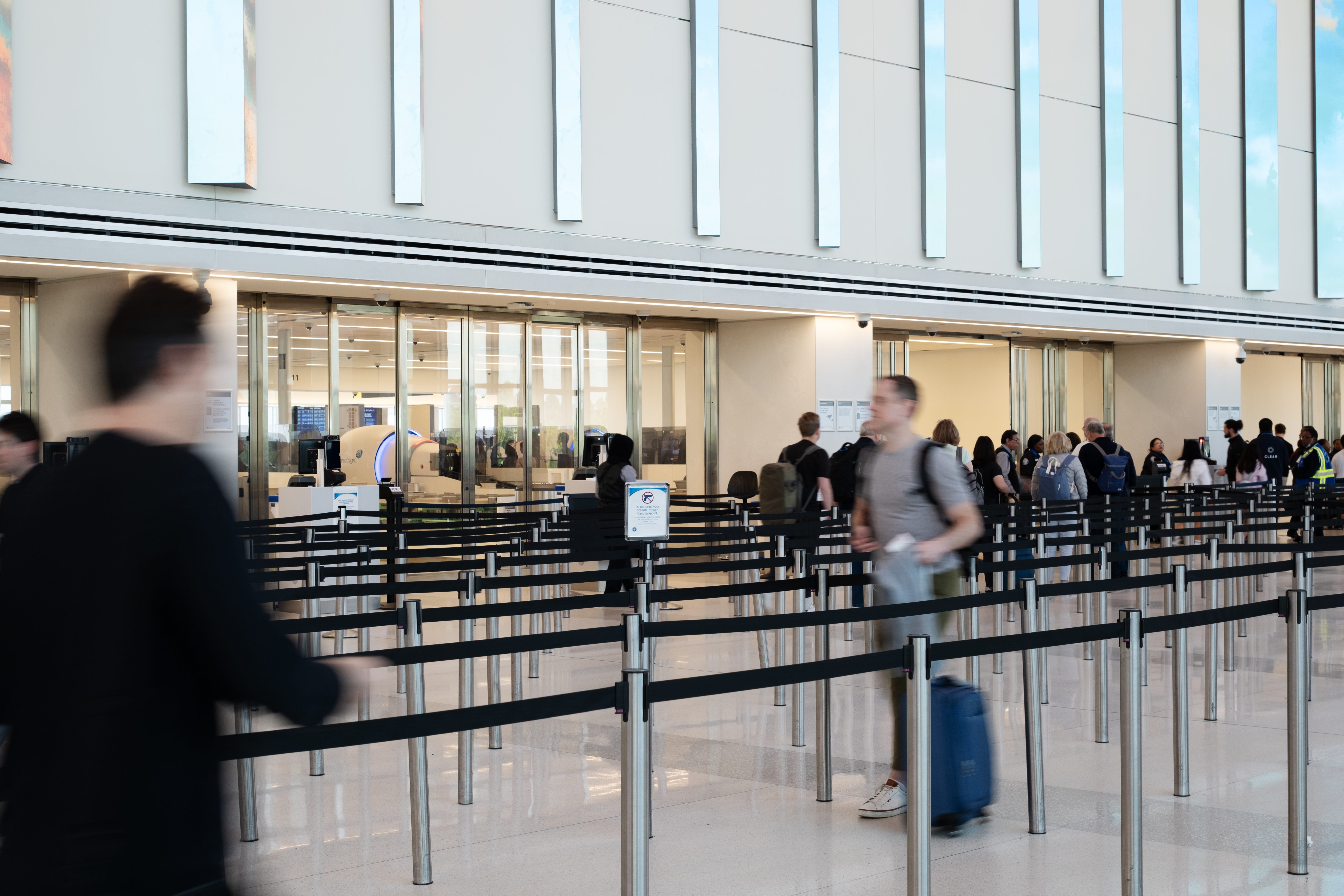 A man walking through security at the airport