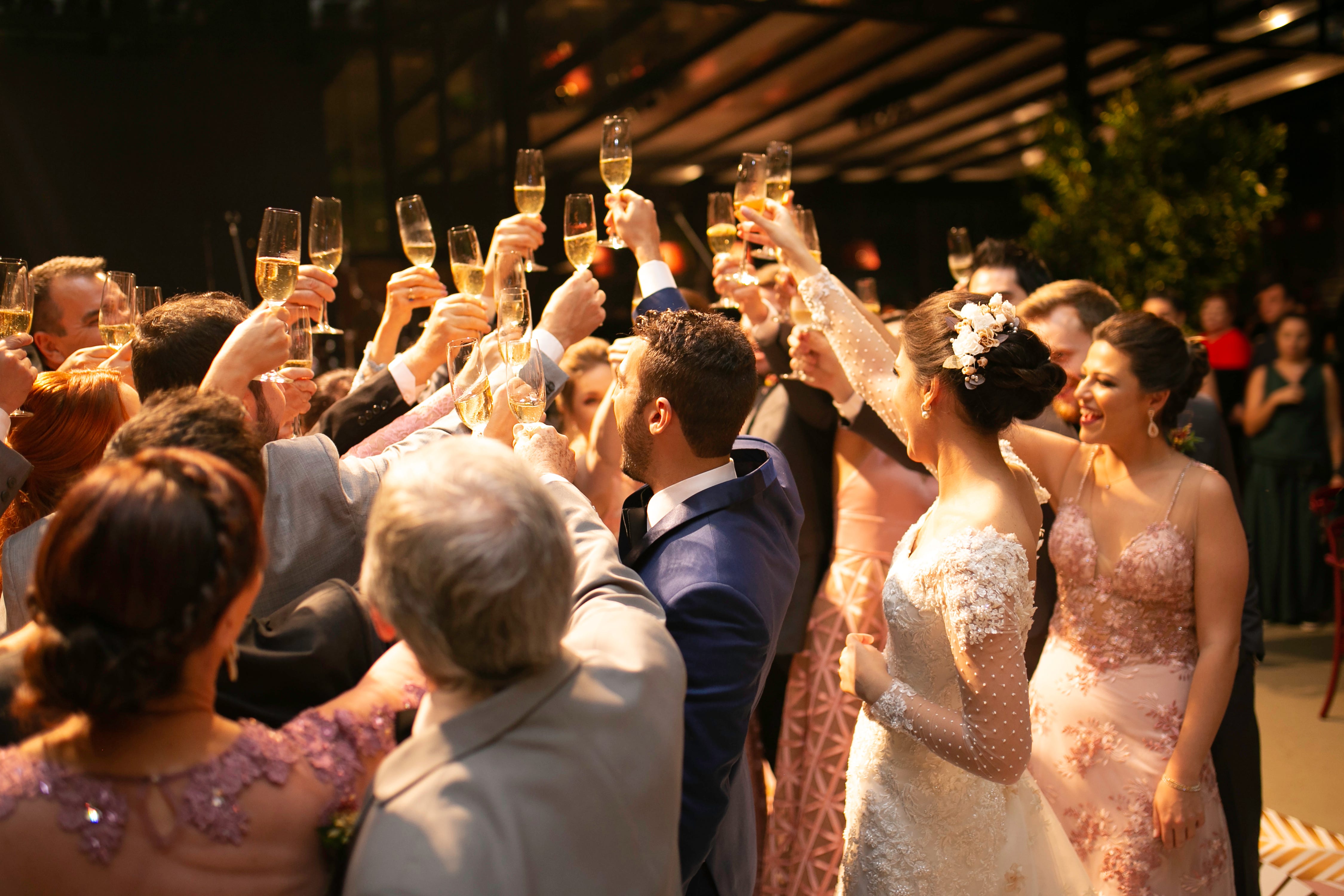Bride, groom and wedding guests making a toast