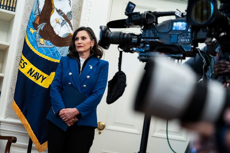 Michigan Gov. Gretchen Whitmer standing awkwardly in the Oval Office as President Donald Trump signs executive orders on April 09, 2025.