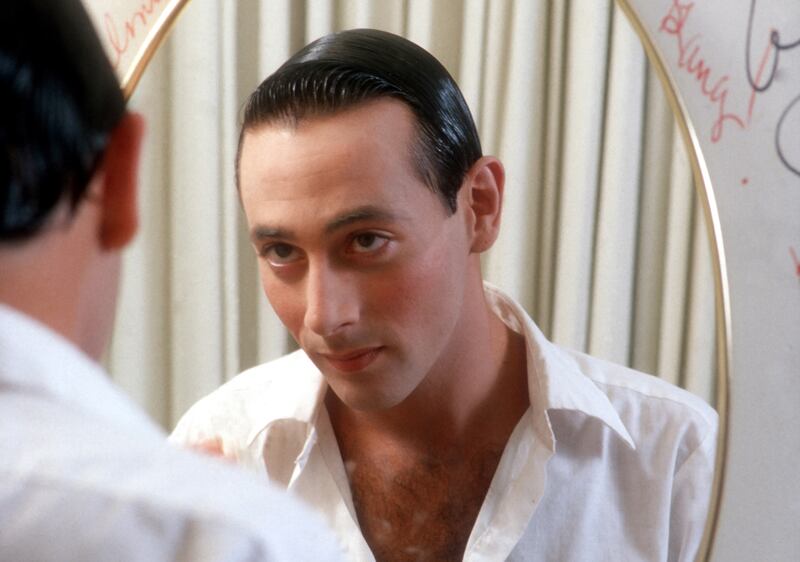 Paul Reubens transforms himself in the mirror into his character Pee-wee Herman in May 1980 in Los Angeles, California.