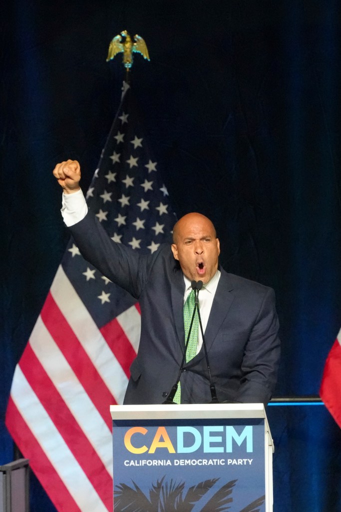 Booker raises his fist in the air during his appearance in California.