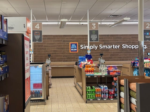 Aldi checkout area - empty aisles, bagging counter in distance