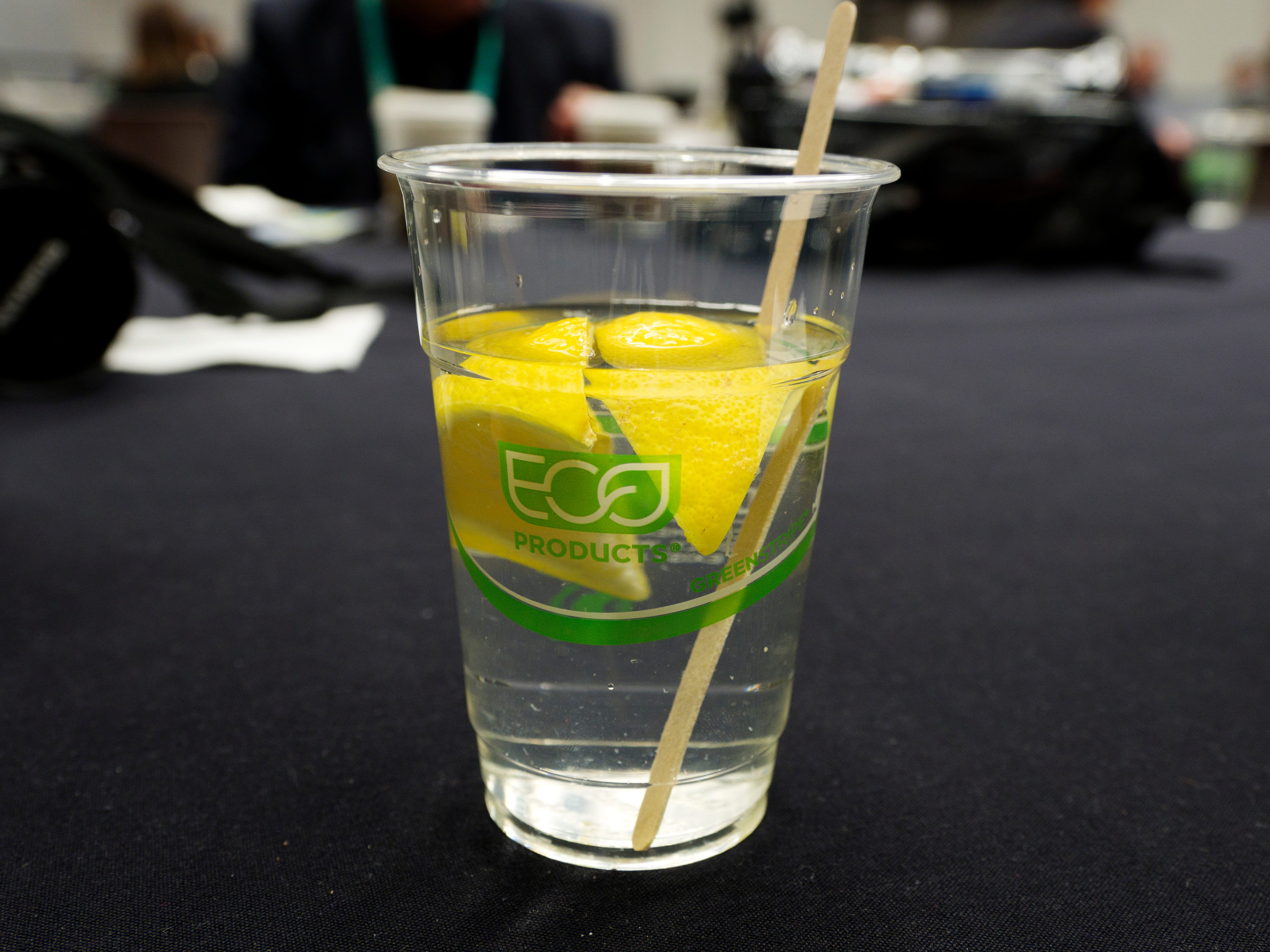 Cup of water with lemon and stirrer