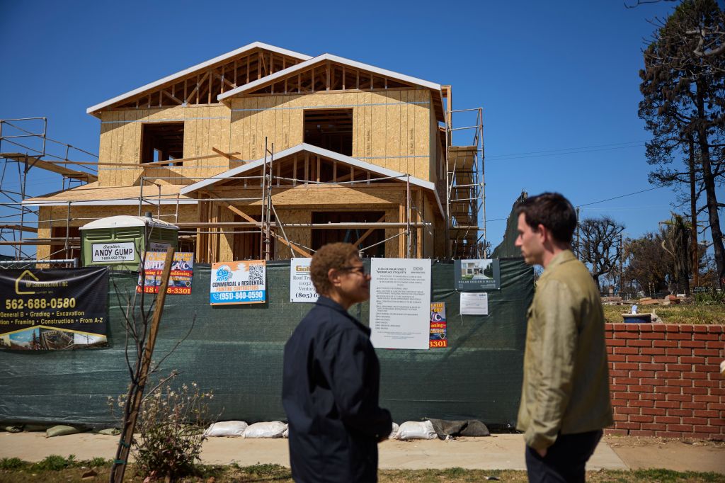 Karen Bass speaks with Lopes at the construction site.