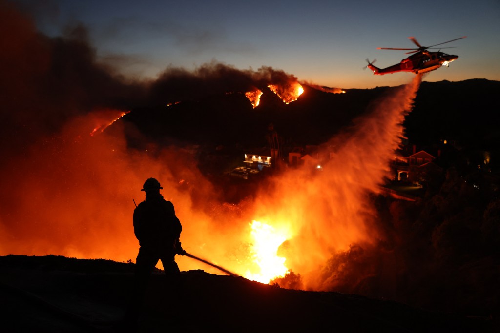 A firefighter battles the Palisades Fire in January.