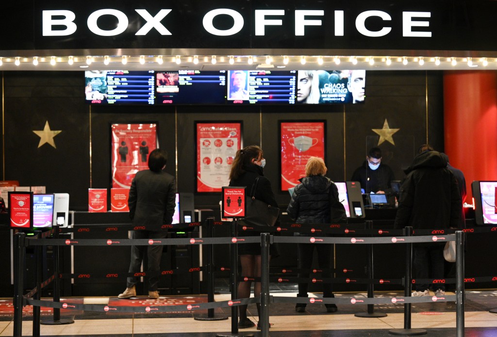 People purchase tickets at a movie theater in New York on March 5, 2021. 