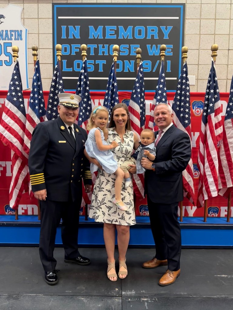 Jackee Dziemian with FDNY Chief John Esposito (left) and FDNY Commish Robert Tucker (right) at the ceremony.