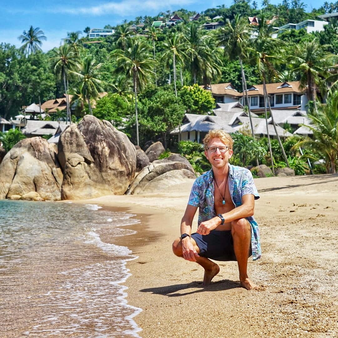 A man taking a photo on the beach.