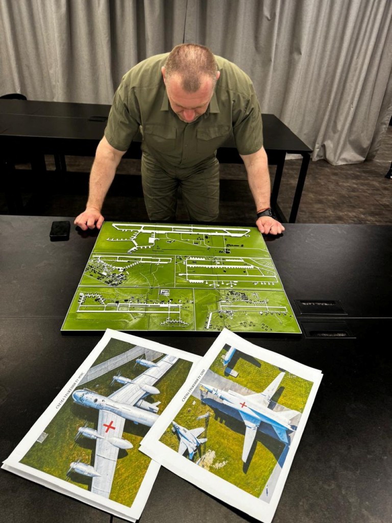Maliuk examining a map of an airfield on the day of Ukraine's strikes against Russia.