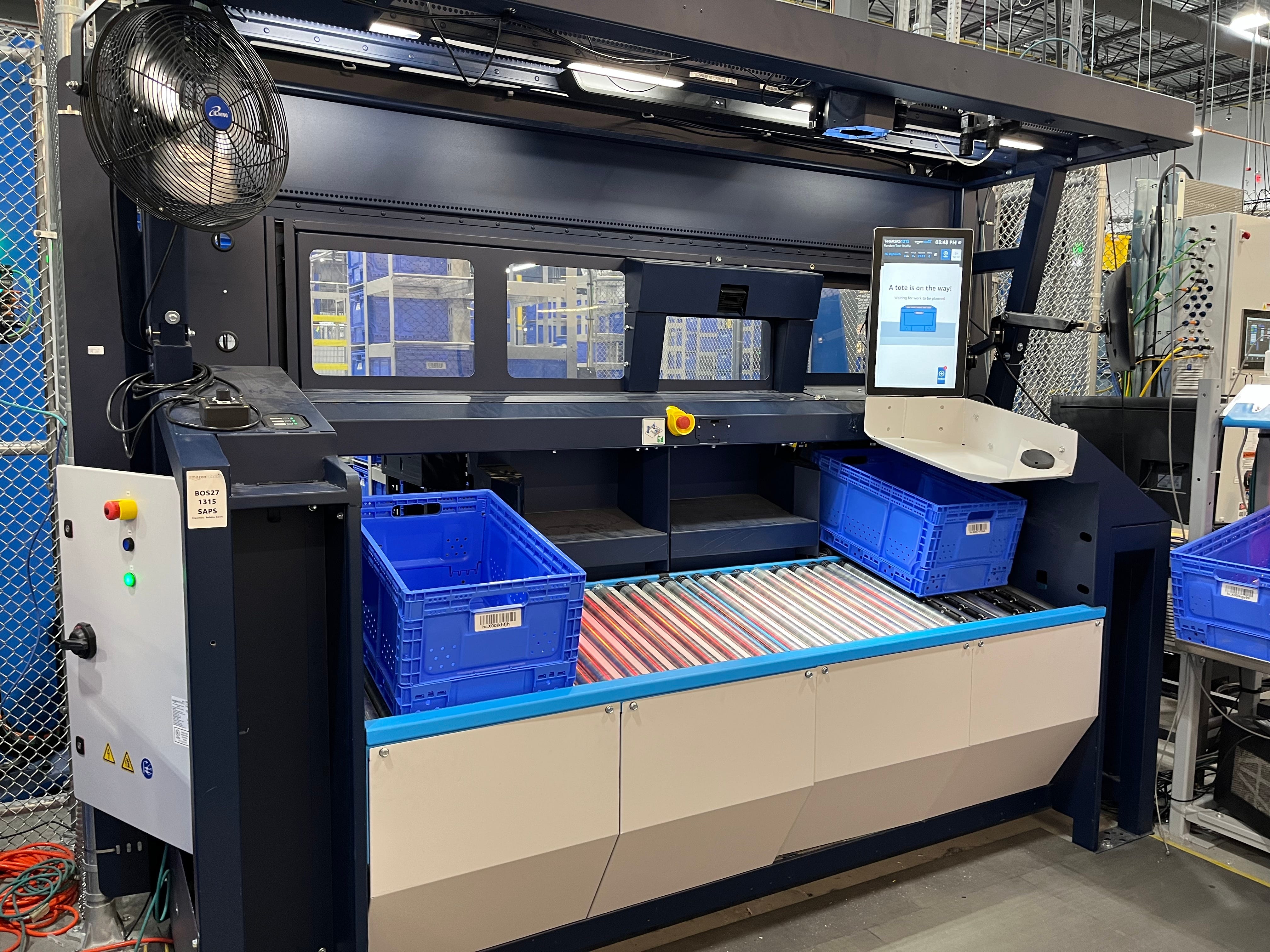 Sequoia storage system has blue totes and a screen that says a tote is on the way