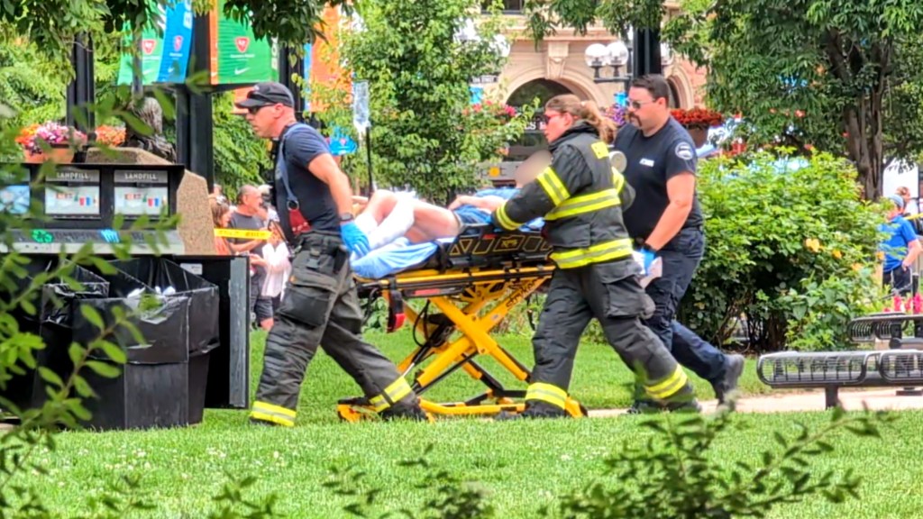 A victim is seen being stretchered out of the scene.