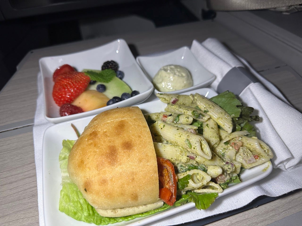 Sandwich with pasta, fruit on American Airlines flight